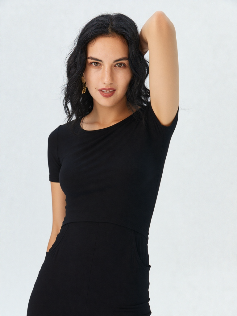 A woman wearing a black nursing one-piece against a light grey background