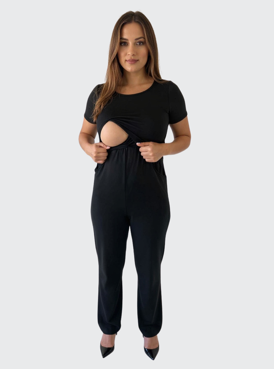 A woman demonstrating the nursing access in her black jumpsuit
