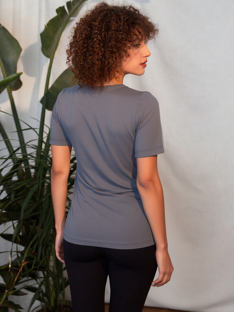 A woman demonstrating the back of her discreet nursing tee