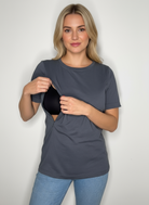 A woman opening her nursing tee